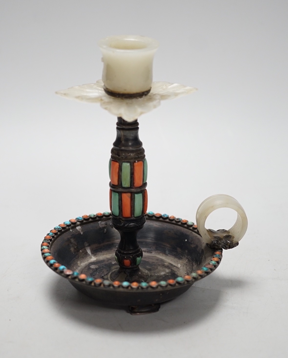 A Chinese white metal jade, coral and turquoise mounted chamberstick, late 19th century, the jade possibly earlier 15cm